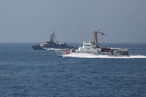 The Coast Guard patrol boat USCGC Wrangell (WPB 1332), front, and the Navy coastal patrol ship USS Monsoon (PC 4), both attached to Task Force (TF) 55, participate in the joint air operations in support of maritime surface warfare (AOMSW) exercise in the Arabian Gulf, Sept. 23. Combined integration operations between joint U.S. forces are regularly held to maintain interoperability and the capability to counter threats posed in the maritime domain, ensuring freedom of navigation and free flow of commerce throughout the region's heavily trafficked waterways. (U.S. Army photo by Spc. Joshua DuRant)