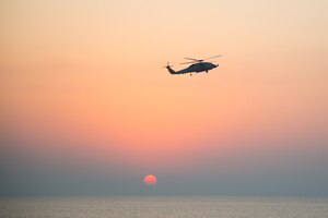 An MH-60R Seahawk helicopter participates in the joint air operations in support of maritime surface warfare (AOMSW) exercise in the Arabian Gulf, Sept. 24. Combined integration operations between joint U.S. forces are regularly held to maintain interoperability and the capability to counter threats posed in the maritime domain, ensuring freedom of navigation and free flow of commerce throughout the region's heavily trafficked waterways. (U.S. Army photo by Spc. Joshua DuRant)