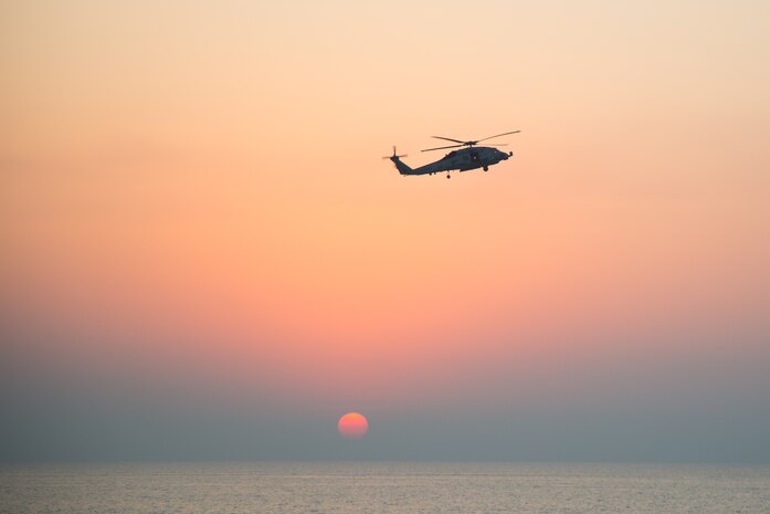 An MH-60R Seahawk helicopter participates in the joint air operations in support of maritime surface warfare (AOMSW) exercise in the Arabian Gulf, Sept. 24. Combined integration operations between joint U.S. forces are regularly held to maintain interoperability and the capability to counter threats posed in the maritime domain, ensuring freedom of navigation and free flow of commerce throughout the region's heavily trafficked waterways. (U.S. Army photo by Spc. Joshua DuRant)