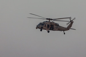 An MH-60R Seahawk helicopter conducts support of the joint air operations in support of maritime surface warfare (AOMSW) exercise in the Arabian Gulf, Sept. 24. Combined integration operations between joint U.S. forces are regularly held to maintain interoperability and the capability to counter threats posed in the maritime domain, ensuring freedom of navigation and free flow of commerce throughout the region's heavily trafficked waterways. (U.S Army photo by Spc. William Gore)