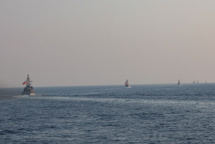 Navy coastal patrol ships and Coast Guard patrol boats, attached to Task Force (TF) 55, sail in formation during the joint air operations in support of maritime surface warfare (AOMSW) exercise in the Arabian Gulf, Sept. 24. Combined integration operations between joint U.S. forces are regularly held to maintain interoperability and the capability to counter threats posed in the maritime domain, ensuring freedom of navigation and free flow of commerce throughout the region's heavily trafficked waterways. (U.S Army photo by Spc. William Gore)