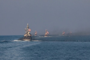 Navy coastal patrol ships and Coast Guard patrol boats, attached to Task Force (TF) 55, sail in formation during the joint air operations in support of maritime surface warfare (AOMSW) exercise in the Arabian Gulf, Sept. 24. Combined integration operations between joint U.S. forces are regularly held to maintain interoperability and the capability to counter threats posed in the maritime domain, ensuring freedom of navigation and free flow of commerce throughout the region's heavily trafficked waterways. (U.S Army photo by Spc. William Gore)