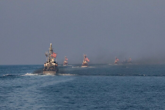 Navy coastal patrol ships and Coast Guard patrol boats, attached to Task Force (TF) 55, sail in formation during the joint air operations in support of maritime surface warfare (AOMSW) exercise in the Arabian Gulf, Sept. 24. Combined integration operations between joint U.S. forces are regularly held to maintain interoperability and the capability to counter threats posed in the maritime domain, ensuring freedom of navigation and free flow of commerce throughout the region's heavily trafficked waterways. (U.S Army photo by Spc. William Gore)