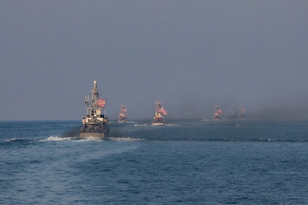 Navy coastal patrol ships and Coast Guard patrol boats, attached to Task Force (TF) 55, sail in formation during the joint air operations in support of maritime surface warfare (AOMSW) exercise in the Arabian Gulf, Sept. 24. Combined integration operations between joint U.S. forces are regularly held to maintain interoperability and the capability to counter threats posed in the maritime domain, ensuring freedom of navigation and free flow of commerce throughout the region's heavily trafficked waterways. (U.S Army photo by Spc. William Gore)