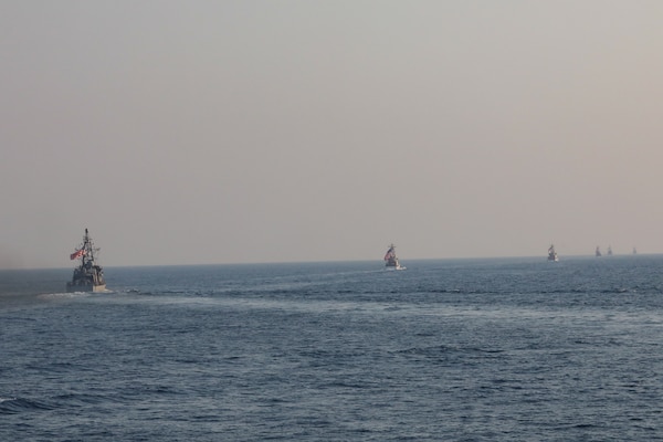Navy coastal patrol ships and Coast Guard patrol boats, attached to Task Force (TF) 55, sail in formation during the joint air operations in support of maritime surface warfare (AOMSW) exercise in the Arabian Gulf, Sept. 24. Combined integration operations between joint U.S. forces are regularly held to maintain interoperability and the capability to counter threats posed in the maritime domain, ensuring freedom of navigation and free flow of commerce throughout the region's heavily trafficked waterways. (U.S Army photo by Spc. William Gore)