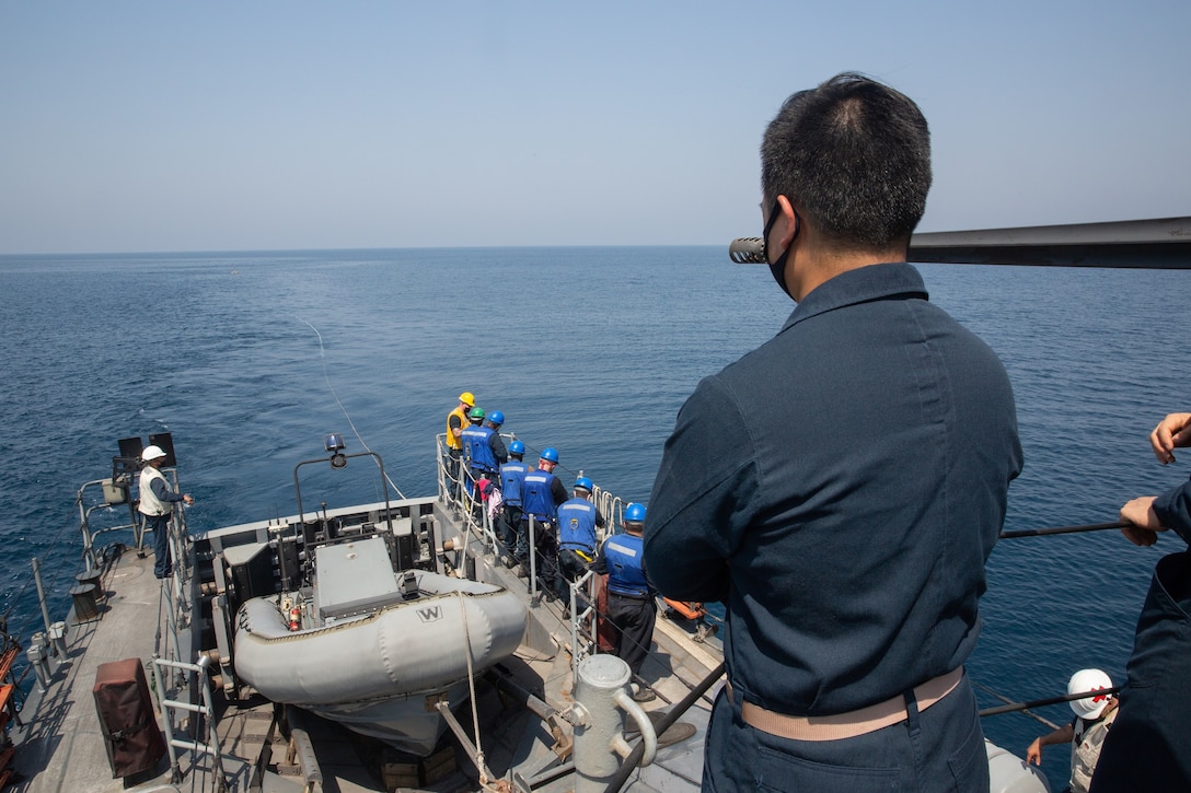 200924-A-RX269-1060 ARABIAN GULF (Sept. 24, 2020) - Sailors assigned to the Navy coastal patrol ship USS Whirlwind (PC 11) set up a target for an aerial gunnery drill during the joint air operations in support of maritime surface warfare (AOMSW) exercise in the Arabian Gulf, Sept. 24. Combined integration operations between joint U.S. forces are regularly held to maintain interoperability and the capability to counter threats posed in the maritime domain, ensuring freedom of navigation and free flow of commerce throughout the region's heavily trafficked waterways.