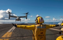 200926-N-DL524-2258 PHILIPPINE SEA- An MV-22 Osprey, assigned to Marine Medium Tiltrotor Squadron (VMM) 262, lands on the flight deck of the aircraft carrier USS Ronald Reagan (CVN 76), during integrated Expeditionary Strike Force operations with the USS America (LHA 6). The Ronald Reagan Carrier Strike Group and America Expeditionary Strike Group with the embarked 31st MEU are forward-deployed to the U.S. 7th Fleet area of operations in support of security and stability in the Indo-Pacific. (U.S. Navy photo by Mass Communication Specialist 2nd Class Erica Bechard/ Released)