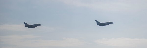 Two Royal Air Force Typhoon fighter jets execute a fly by exercise with the Arleigh Burke-class guided-missile destroyer USS Roosevelt (DDG 80), Sept. 25, 2020. Roosevelt, forward-deployed to Rota, Spain, is on its first patrol in the U.S. Sixth Fleet area of operations in support of regional allies and partners and U.S. national security interests in Europe and Africa.