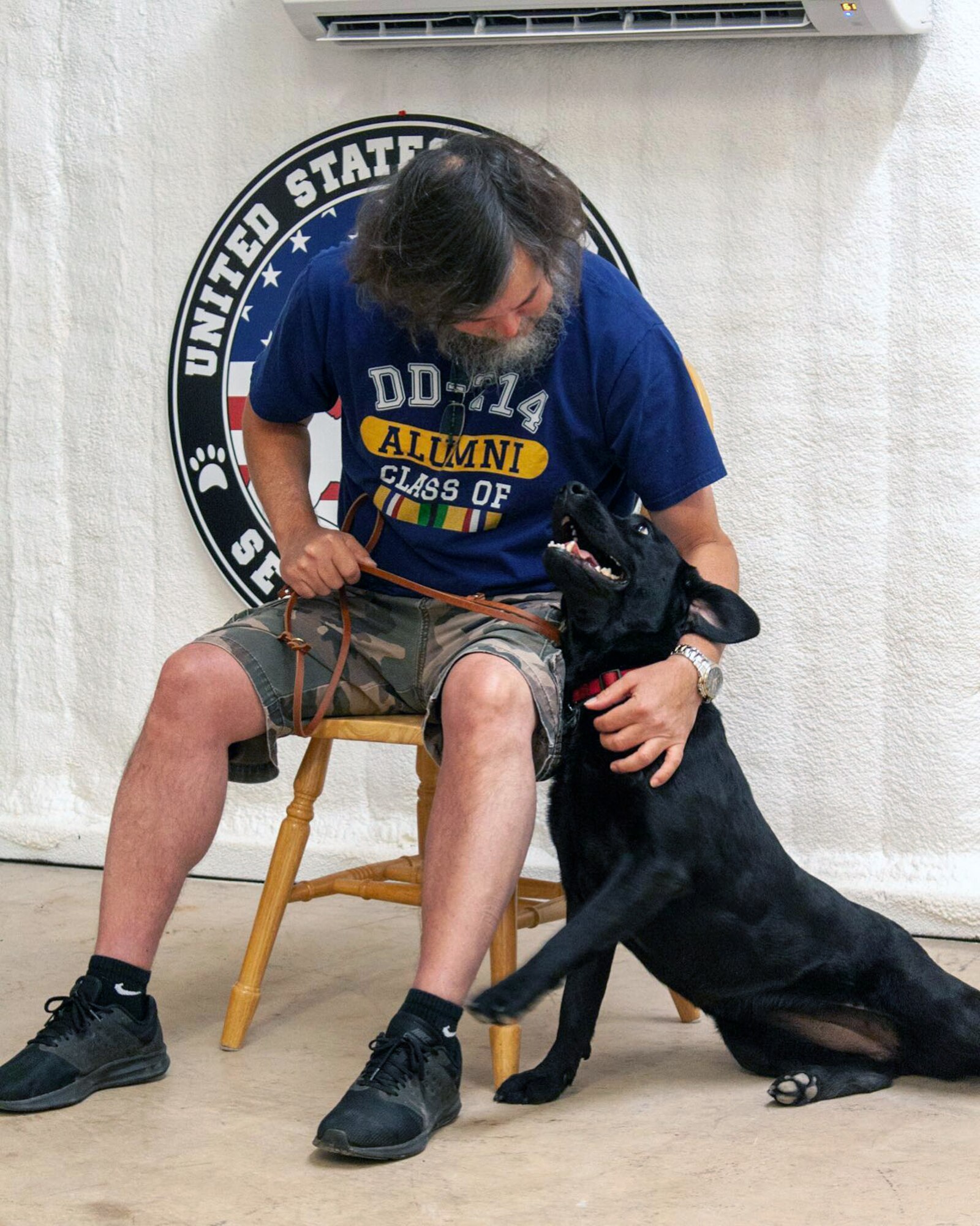 A veteran meets his new service dog. Chairs are set-up for veterans on graduation day at the United States Veterans Service Dogs satellite training facility in Bergheim, Texas, where service dogs are paired with their new owners.