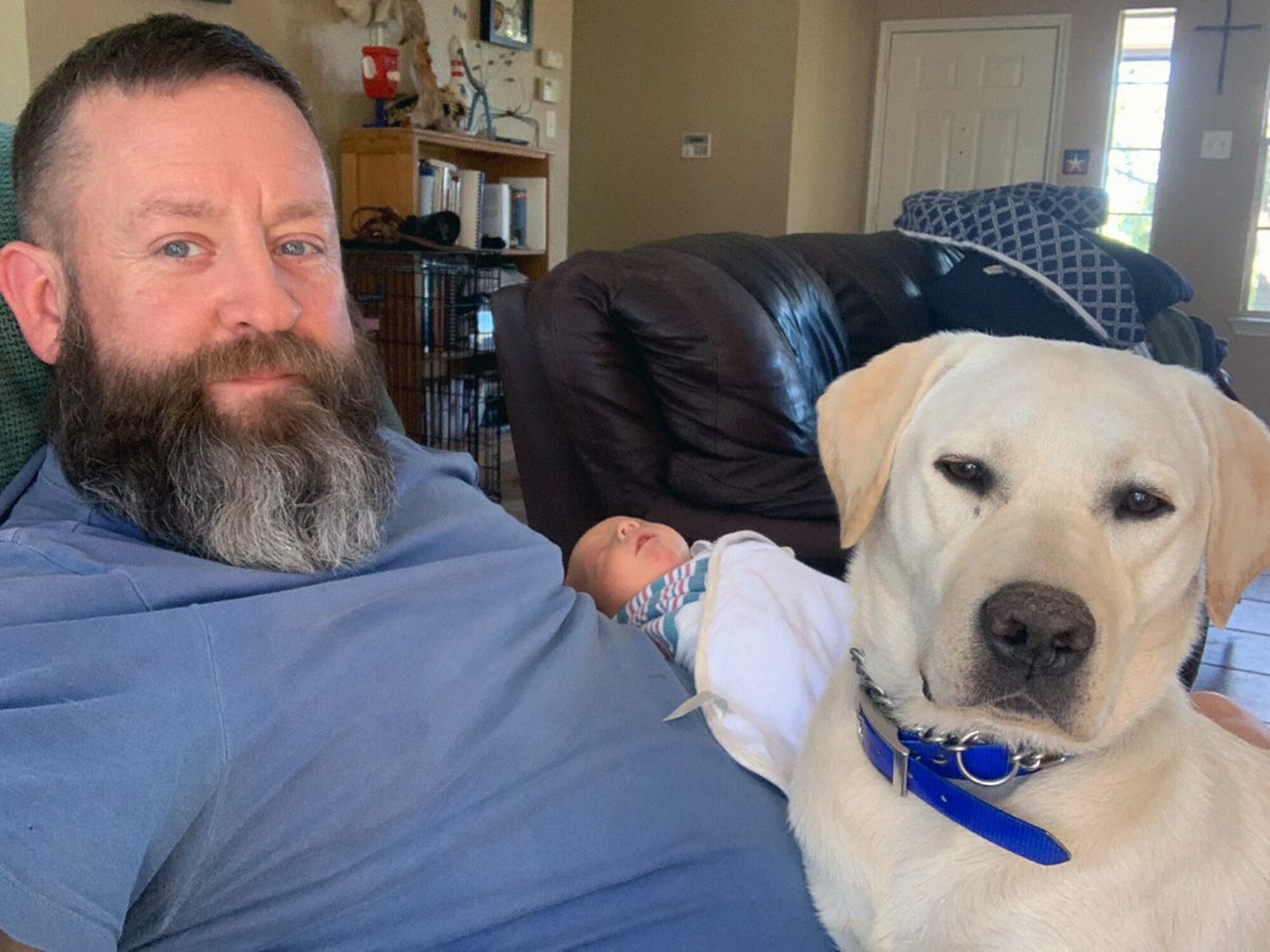 Veteran Andrew Camplen, at home, welcomes his newborn baby boy, with his service dog, Sebastian, who never leaves his side, winter 2019. After separation from the Air Force and working for the San Antonio police department, Camplen realized that he needed a service dog. Camplen is now the Director of Client Services for the United States Veterans Service Dogs, which was created for and dedicated to helping veterans return to a new “Normal” by training and placing quality service dogs with veterans.