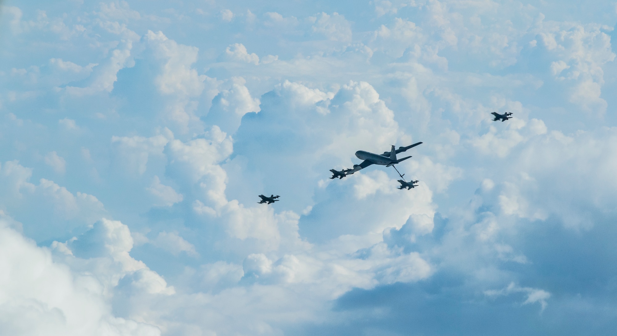 A U.S. Air Force KC-135 Stratotanker refuels U.S. Air Force F-16 Fighting Falcons during an airborne refueling exercise over Poland, Sept. 24, 2020. The KC-135 refueled F-16 Fighting Falcon aircraft from the 52nd Fighter Wing at Spangdahlem Air Base numerous times during sorties as part of joint multinational exercise Astral Knight. (U.S. Air Force photo by Airman 1st Class Alison Stewart)