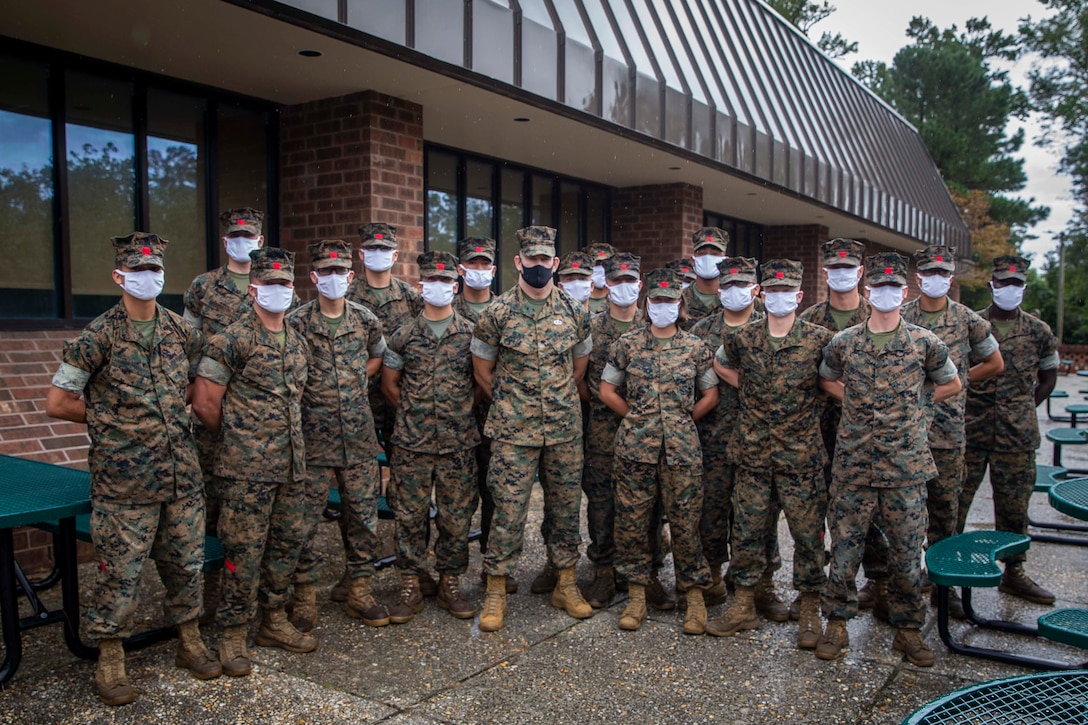 The 19th Sergeant Major of the Marine Corps, Sgt. Maj. Troy E. Black stands for a photo with Marines attending the Landing Support Specialist Course at Marine Corps Combat Service Support School (MCCSSS) at Marine Corps Base Camp Johnson, Jacksonville, N.C., Sept. 17, 2020. During the visit Sgt. Maj. Black discussed the importance of sustaining the transformation as Marines prepare to graduate from their entry level school. MCCSSS develops, conducts and evaluates formal training for entry, intermediate and advanced level officer, enlisted and civilian students in Personnel Administration, Ground Supply Support and Distribution, Financial Management and Logistics Operations, as well as Marine Corps Water Survival training. (U.S. Marine Corps photo by Sgt. Victoria Ross)
