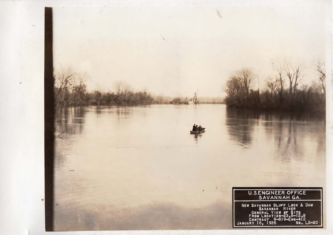 Men survey the flooded site from a boat, 1935.