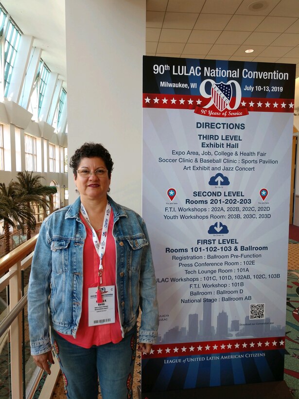 Martha Kerns near a poster at a conference