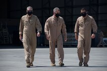 Vice Adm. Samuel Paparo, center, commander, U.S. Naval Forces Central Command, U.S. 5th Fleet, and Combined Maritime Forces, Capt. James Johnston, left, commodore, Commander Task Force (CTF) 57, left, and Cmdr. Kevin Kraemer, commanding officer, Patrol Squadron (VP) 16, walk the flight-line prior to boarding a P-8A Poseidon aircraft, Sept. 27. CTF 57 operates in the U.S 5th Fleet area of operations in support of naval operations to ensure maritime stability and security in the Central Region, connecting the Mediterranean and Pacific through the Western Indian Ocean and three strategic chokepoints to the free flow of global commerce. (U.S. Navy photo by Mass Communication Specialist Seaman Mathew Lombardo)