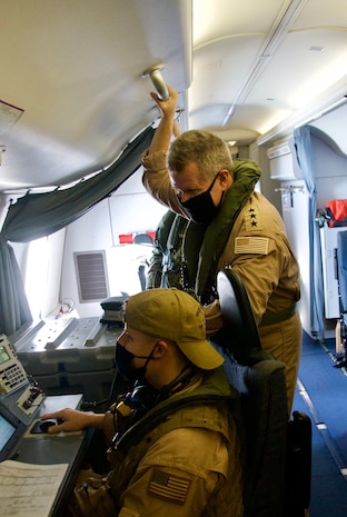 Vice Adm. Samuel Paparo, commander, U.S. Naval Forces Central Command, U.S. 5th Fleet, and Combined Maritime Forces, left, observes as Naval Aircrewman (Operator) 2nd Class Kyen Balzer, assigned to Commander Task Force (CTF) 57 conducts in-flight operations during a P-8A Poseidon flight over the Arabian Gulf and Strait of Hormuz, Sept. 27. CTF 57 operates in the U.S 5th Fleet area of operations in support of naval operations to ensure maritime stability and security in the Central Region, connecting the Mediterranean and Pacific through the Western Indian Ocean and three strategic chokepoints to the free flow of global commerce. (U.S. Navy photo by Mass Communication Specialist Seaman Mathew Lombardo)