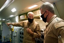 Capt. James Johnston, commodore, Commander Task Force (CTF) 57, left, gives a tour of the P-8A Poseidon aircraft to Vice Adm. Samuel Paparo, commander, U.S. Naval Forces Central Command, U.S. 5th Fleet, and Combined Maritime Forces, during a flight over the Arabian Gulf and Strait of Hormuz, Sept. 27. CTF 57 operates in the U.S 5th Fleet area of operations in support of naval operations to ensure maritime stability and security in the Central Region, connecting the Mediterranean and Pacific through the Western Indian Ocean and three strategic chokepoints to the free flow of global commerce. (U.S. Navy photo by Mass Communication Specialist Seaman Mathew Lombardo)