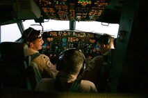 Vice Adm. Samuel Paparo, commander, U.S. Naval Forces Central Command, U.S. 5th Fleet, and Combined Maritime Forces, center, observes as Cmdr. Kevin Kraemer, commanding officer, Patrol Squadron (VP) 16, left, and Lt. Stephen McIntyre fly a P-8A Poseidon aircraft during a flight over the Arabian Gulf and Strait of Hormuz, Sept. 27. CTF 57 operates in the U.S 5th Fleet area of operations in support of naval operations to ensure maritime stability and security in the Central Region, connecting the Mediterranean and Pacific through the Western Indian Ocean and three strategic chokepoints to the free flow of global commerce. (U.S. Navy photo by Mass Communication Specialist Seaman Mathew Lombardo)