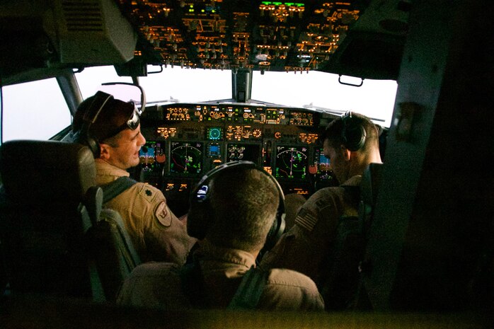 Vice Adm. Samuel Paparo, commander, U.S. Naval Forces Central Command, U.S. 5th Fleet, and Combined Maritime Forces, center, observes as Cmdr. Kevin Kraemer, commanding officer, Patrol Squadron (VP) 16, left, and Lt. Stephen McIntyre fly a P-8A Poseidon aircraft during a flight over the Arabian Gulf and Strait of Hormuz, Sept. 27. CTF 57 operates in the U.S 5th Fleet area of operations in support of naval operations to ensure maritime stability and security in the Central Region, connecting the Mediterranean and Pacific through the Western Indian Ocean and three strategic chokepoints to the free flow of global commerce. (U.S. Navy photo by Mass Communication Specialist Seaman Mathew Lombardo)