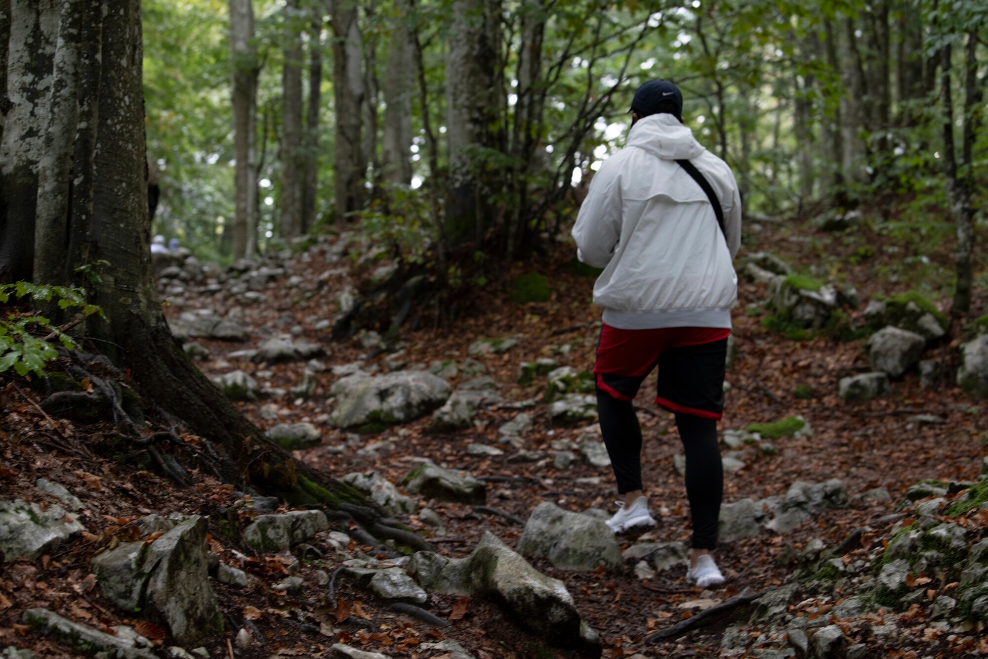 An Airman from the 31st Fighter Wing makes their way up a hill during a scavenger hunt at Piancavallo, Italy, Sept. 22, 2020. The Airmen were required to find items and complete tasks while submitting proof through a phone application. U.S. Air Force photo by Senior Airman Caleb House)