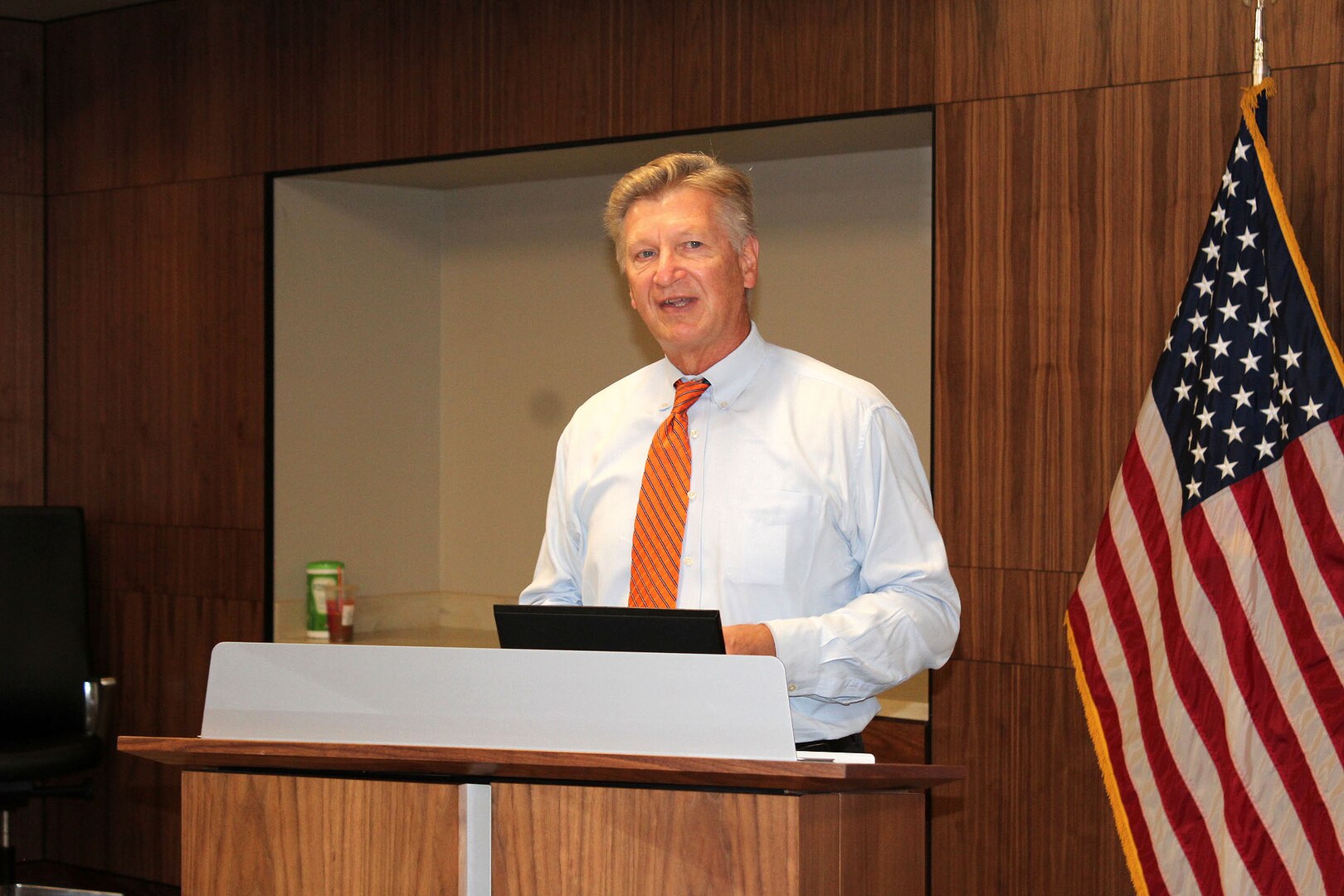 A man speaks at a podium.