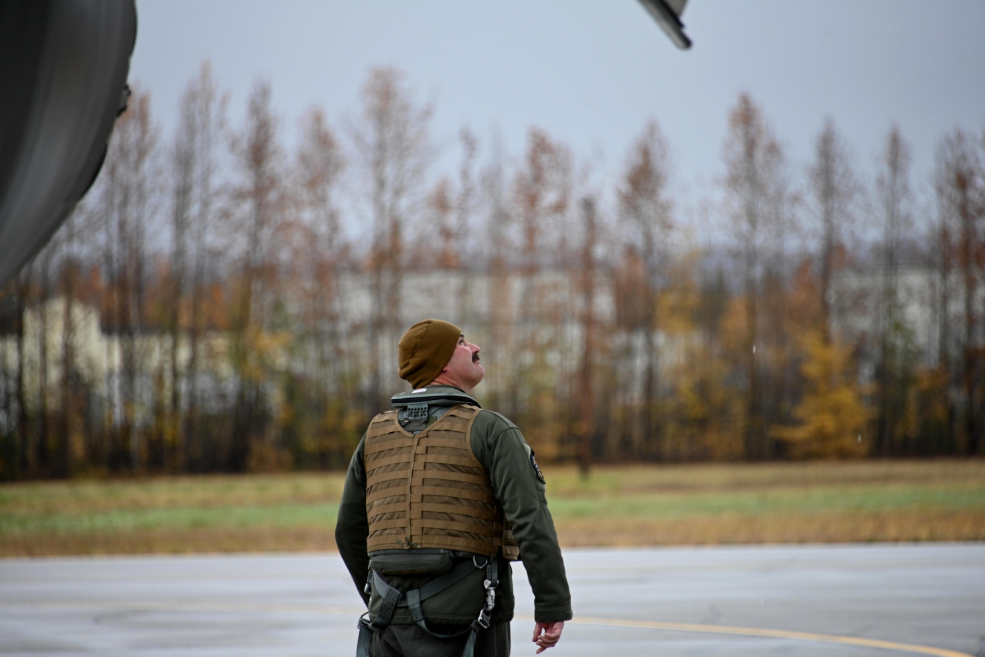Photo of Airman inspecting the exterior of a B-1 Lancer