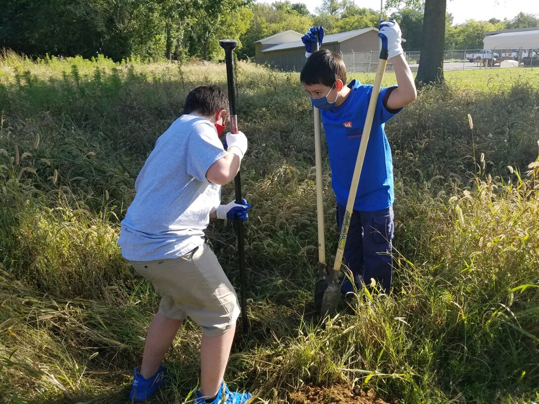 Cub Scouts from Pack 503 dig a hole for a new pollinator habitat sign at Cheatham Lake in Ashland City, Tennessee, Sept. 19, 2020 in support of National Public Lands Day. (USACE photo by Samantha Bedard)