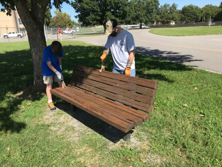 A Cub Scout and leader from Pack 503 paint a park bench at Cheatham Lake in Ashland City, Tennessee, where they volunteered Sept. 19, 2020 in support of National Public Lands Day. (USACE photo by Samantha Bedard)