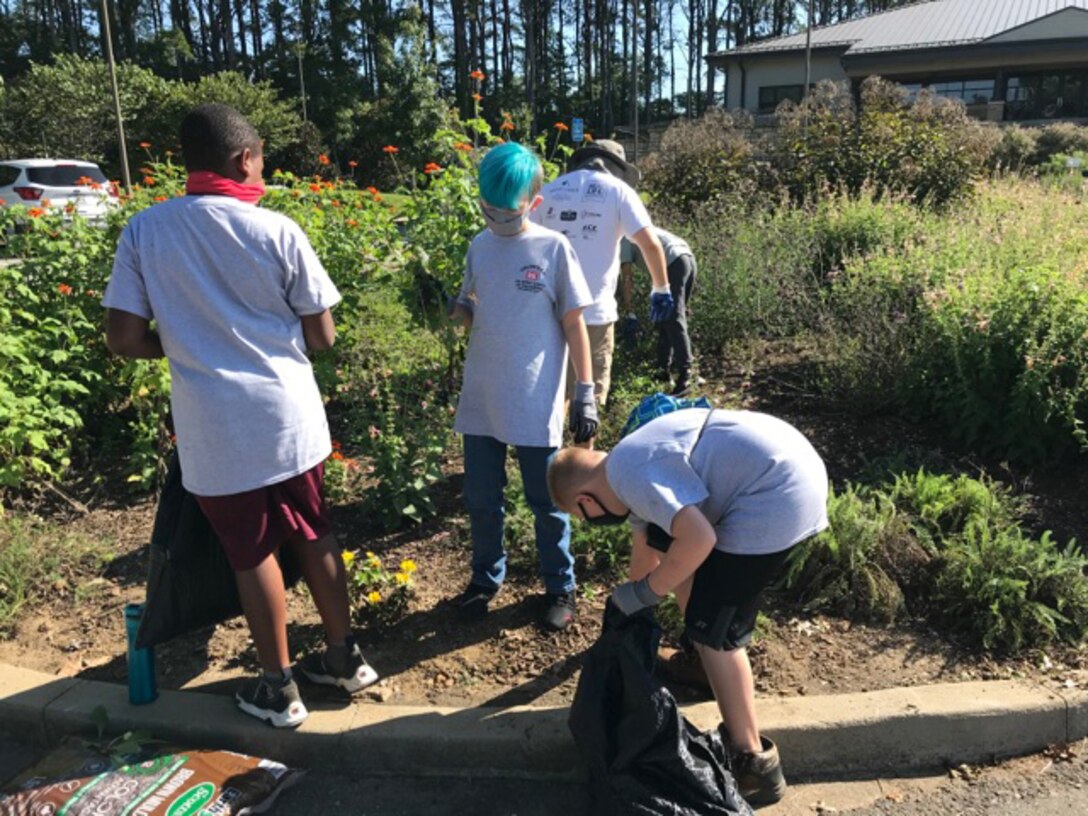 Cub Scouts from Pack 503 work to pick up weeds and clippings from the pollinator garden at Cheatham Lake in Ashland City, Tennessee, Sept. 19, 2020 in support of National Public Lands Day. (USACE photo by Amber Jones)