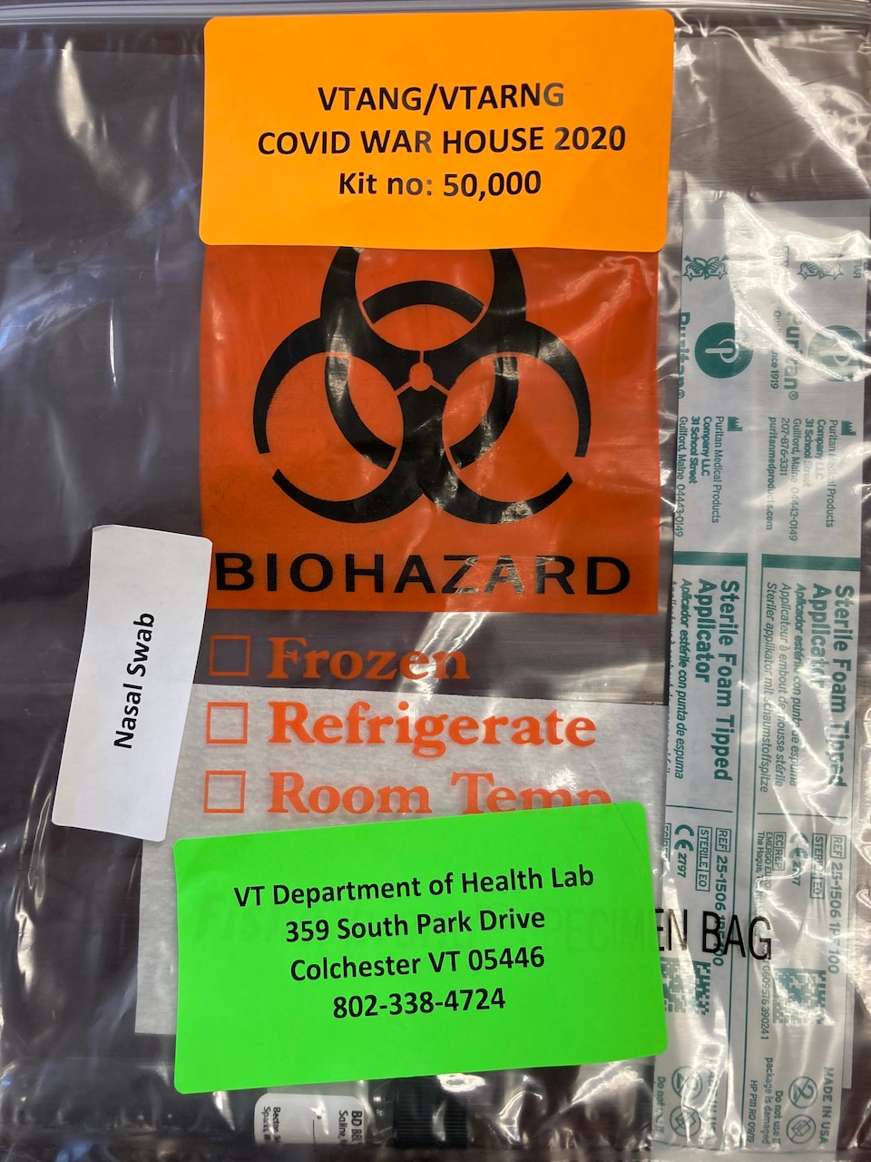 A COVID test kit packed in a bag with biohazard symbol on it.