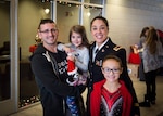 West Virginia National Guard CW3 Siobhan O’Flaherty Cleek poses with her family; husband Khristopher, and daughters Agatha and Paige.