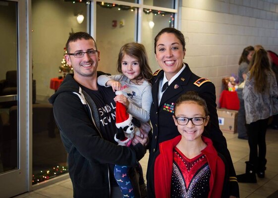 West Virginia National Guard CW3 Siobhan O’Flaherty Cleek poses with her family; husband Khristopher, and daughters Agatha and Paige.