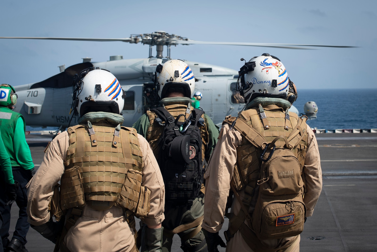 Sailors wait to board an MH-60R Sea Hawk, attached to the "Swamp Foxes" of Helicopter Maritime Strike Squadron 74, on the flight deck aboard the aircraft carrier USS Dwight D. Eisenhower (CVN 69) May 10, 2020. I