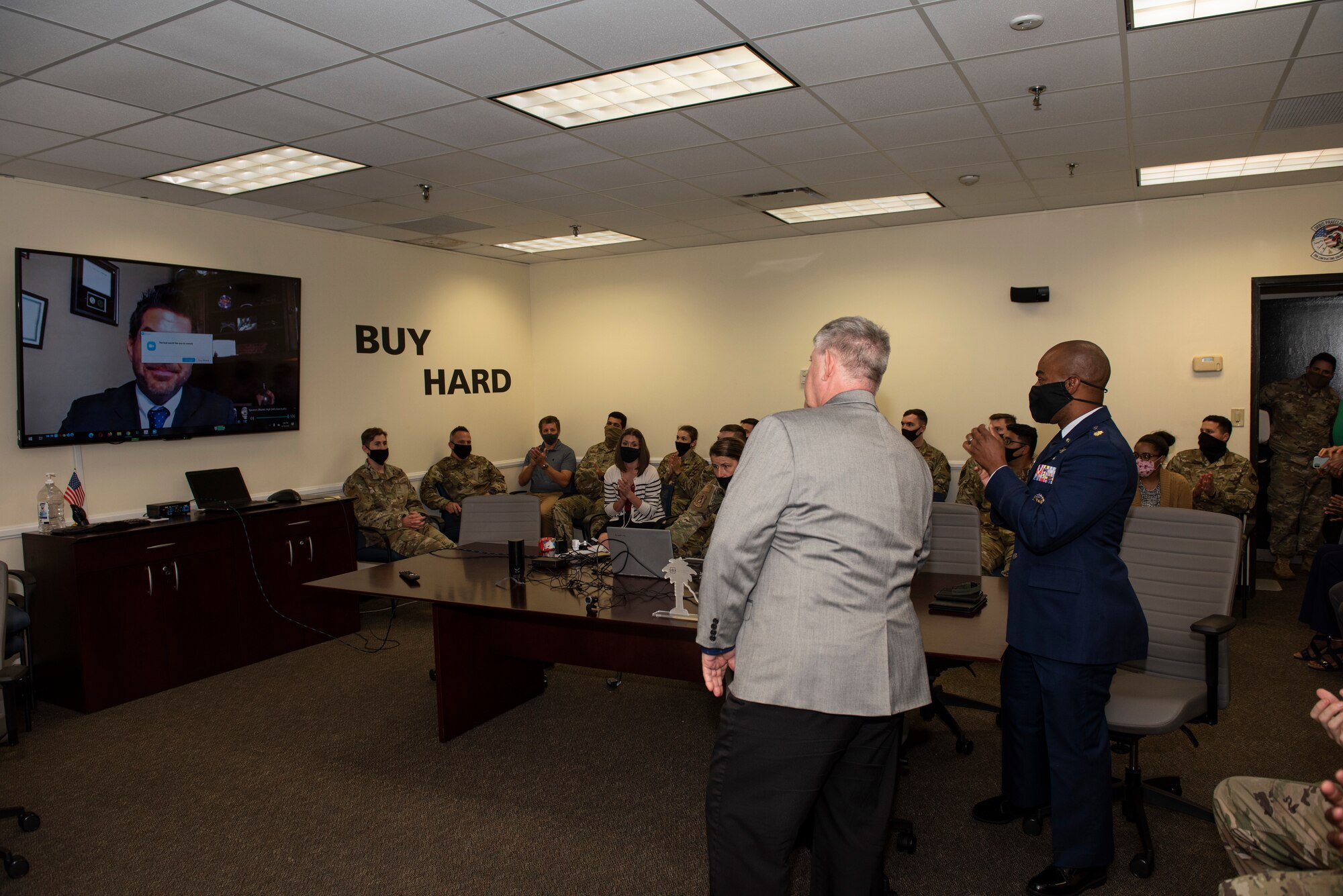 An image of the 20th Contracting Squadron clapping during a teleconference.