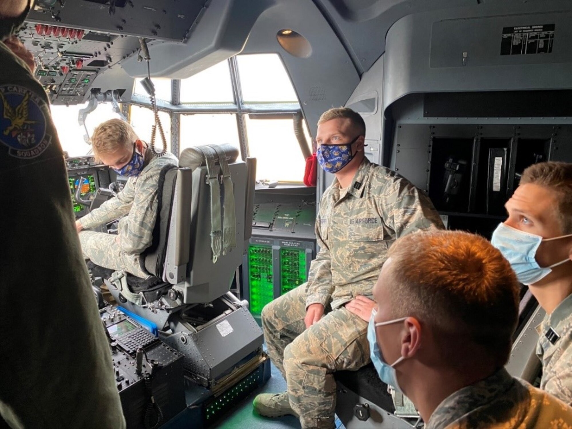 A group of people receive a tour of the C-130J Super Hercules