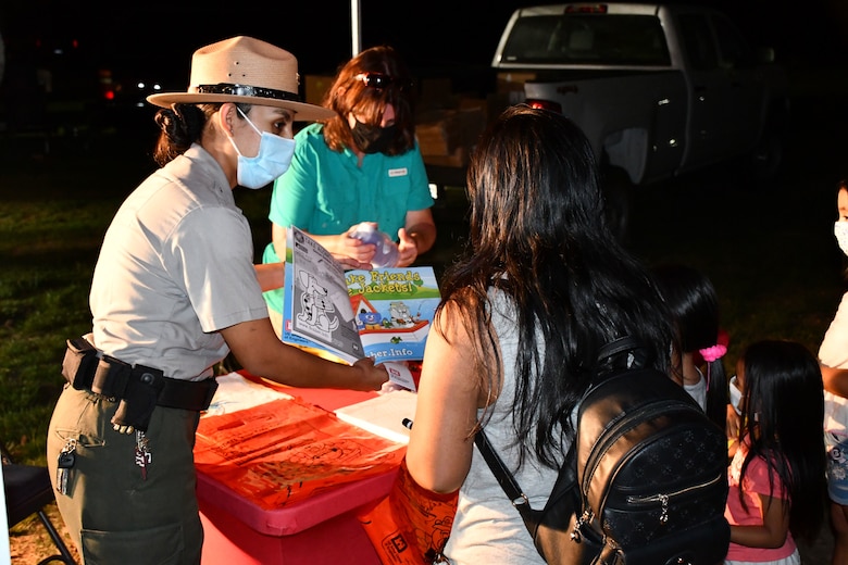 LA District Park Rangers Annel Montsalvo, left, and Linda C. Babcock, hand out information to a family participating in Los Angeles County’s Overnight Family Camping and Fishing Sept. 26 at Whittier Narrows Recreation Area in Montebello, California. Montsalvo and other LA District park rangers used the event as an opportunity to educate members of the public on topics such as water safety, environmental stewardship and flood preparedness as part of National Public Lands Day.
