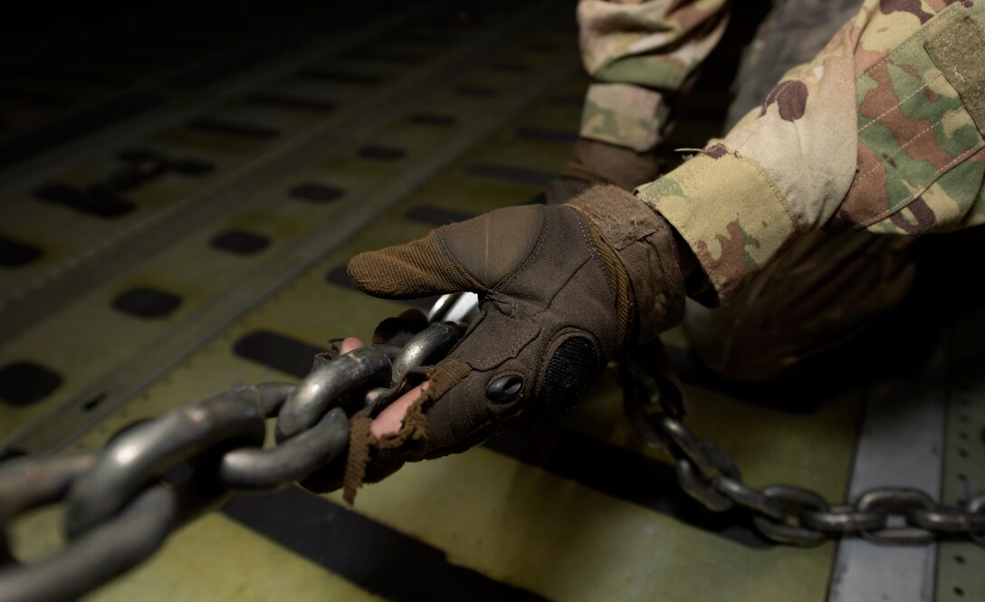 U.S. Airmen and Soldiers train together to load a Chinook-47 helicopter in a C-5M Super Galaxy.