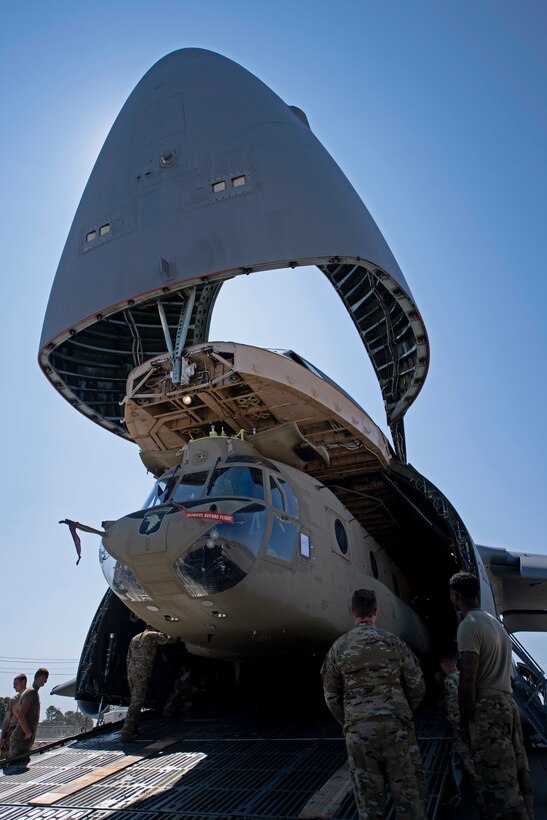 U.S. Airmen and Soldiers train together to load a Chinook-47 helicopter in a C-5M Super Galaxy.