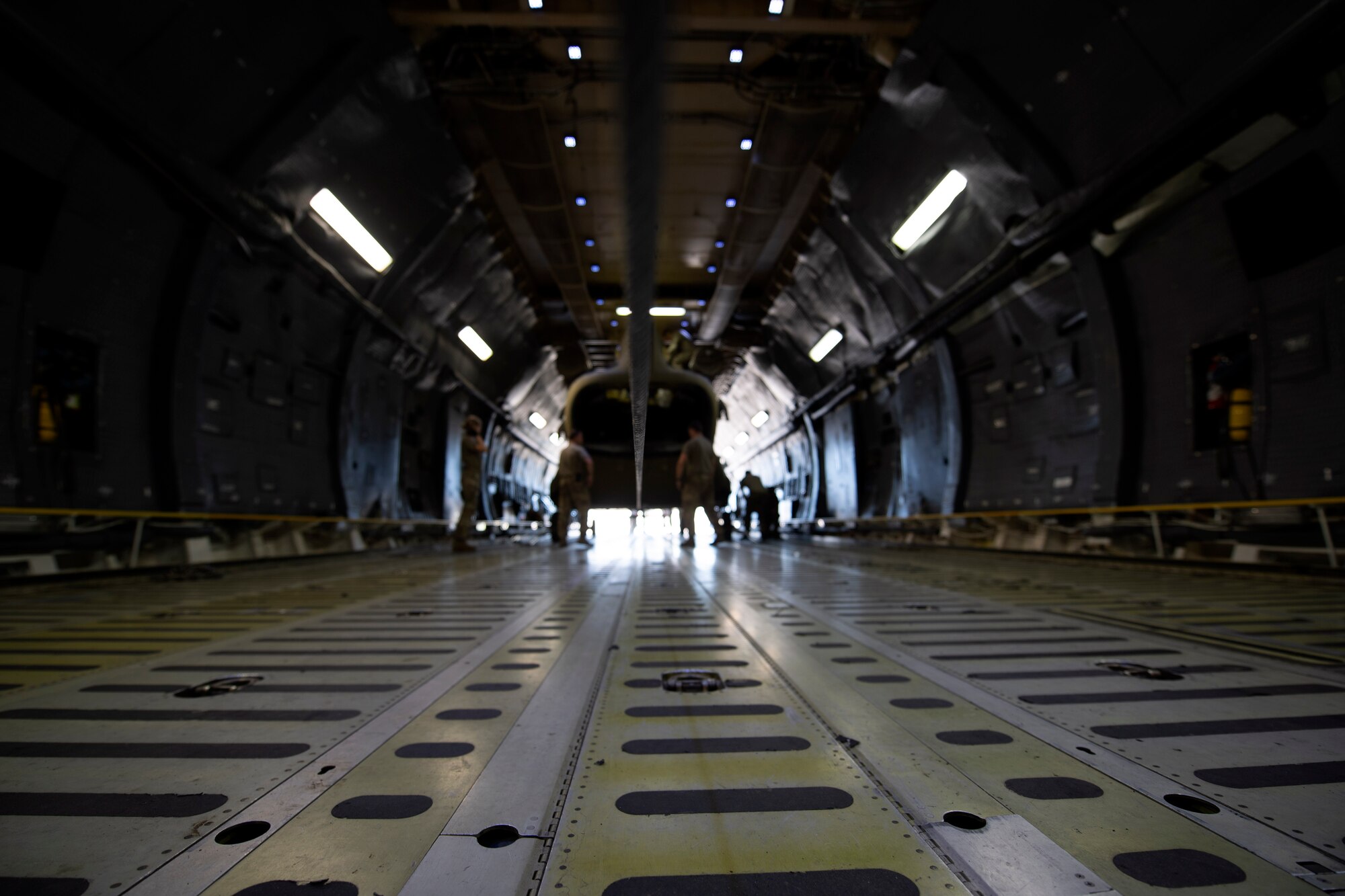 U.S. Airmen and Soldiers train together to load a Chinook-47 helicopter in a C-5M Super Galaxy.