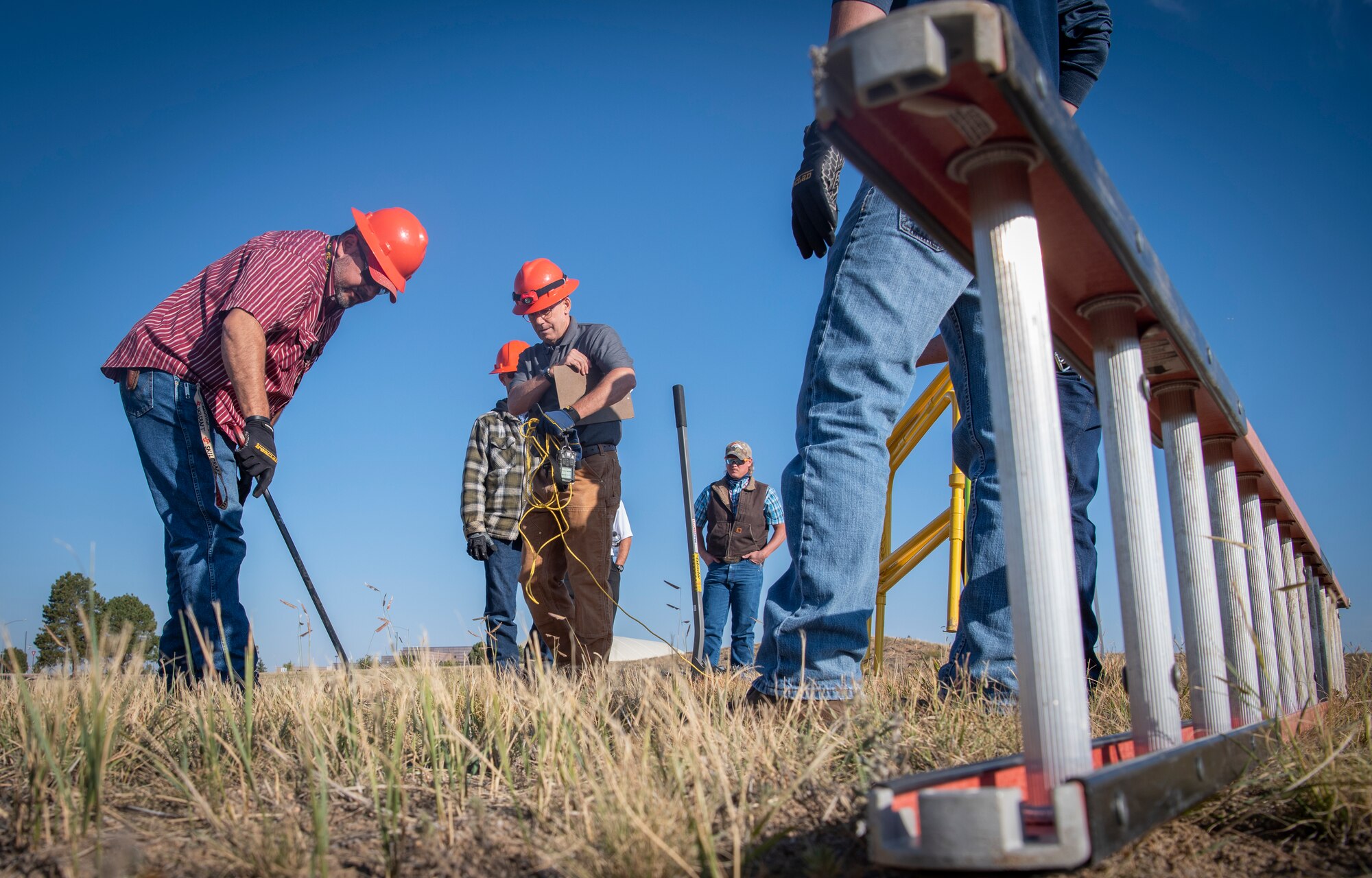 Members of the 50th Space Communications Squadron lift a manhole cover during a confined space training event Sept. 24, 2020, at Schriever Air Force Base, Colorado. A confined space is an area that has a limited means of getting in and out, is not meant for consistent work and is just large enough to enter. (U.S. Space Force photo by Airman 1st Class Jonathan Whitely)