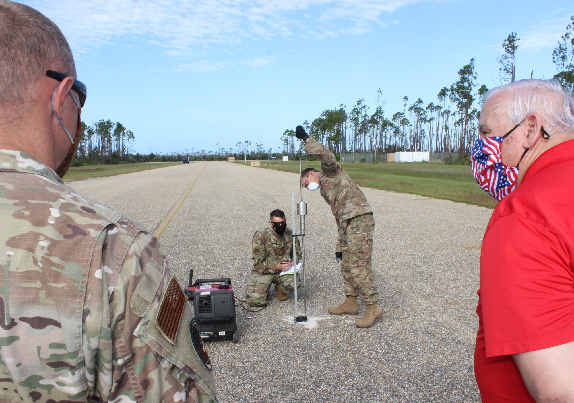 Local area students learn how to assess airfield pavement conditions while Contingency Airfield Pavement Evaluation instructor Dick Smith looks on.