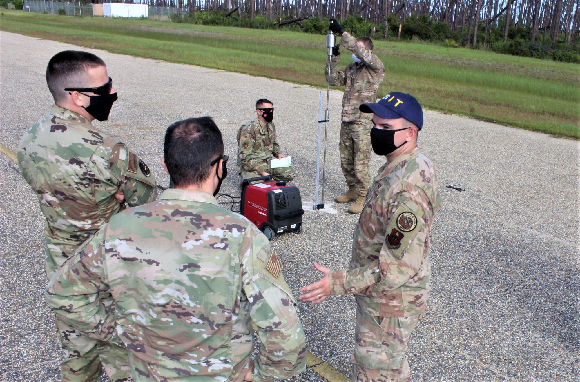 Local area students learn how to assess airfield pavement conditions while Air Force Institute of Technology and Air Force Civil Engineer Center staff talk through the process.
