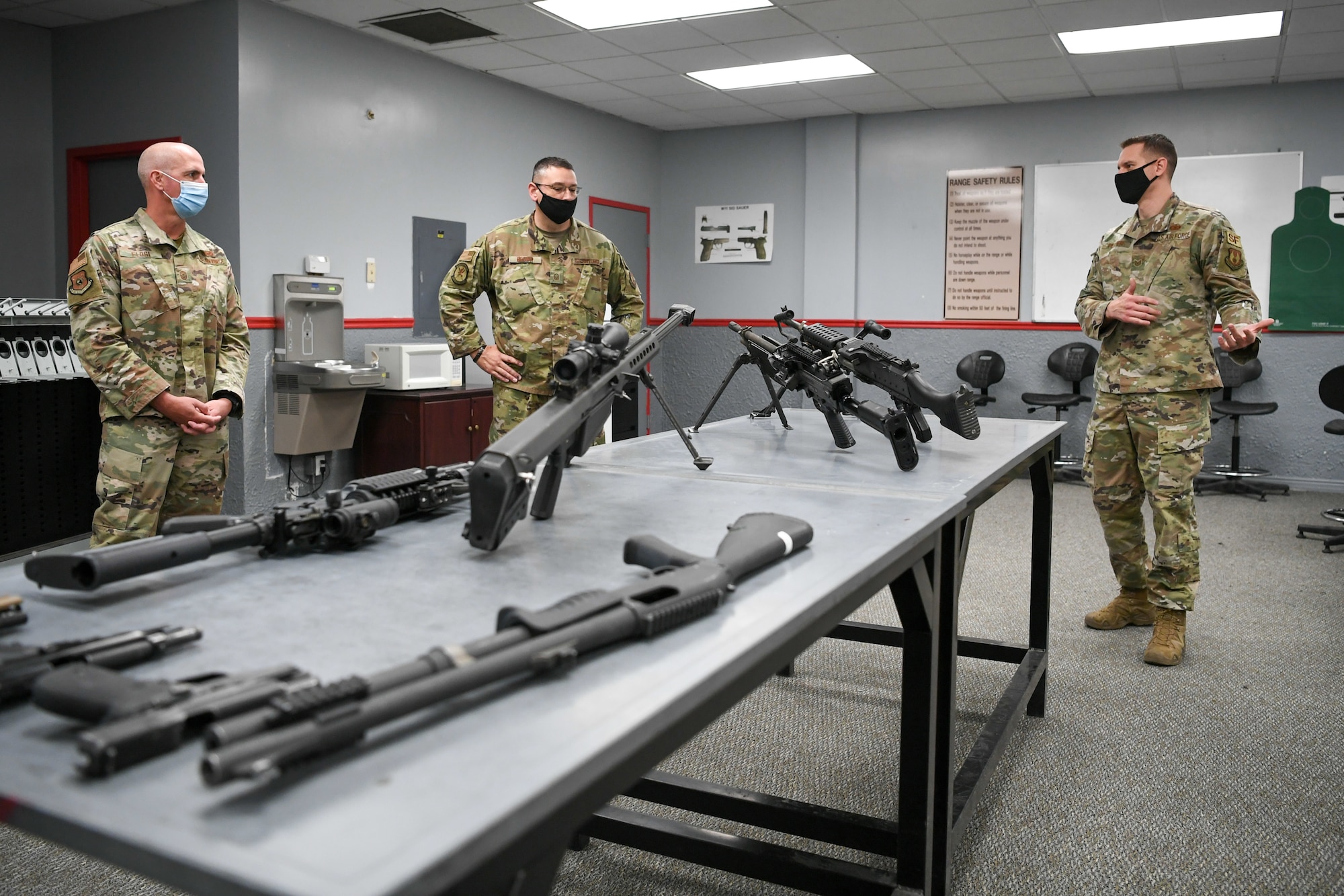 Chief Master Sgt. David Flosi, Air Force Sustainment Center command chief master sergeant, listens to Tech. Sgt. Wayne Pilcher (far right), 75th Security Forces Squadron.