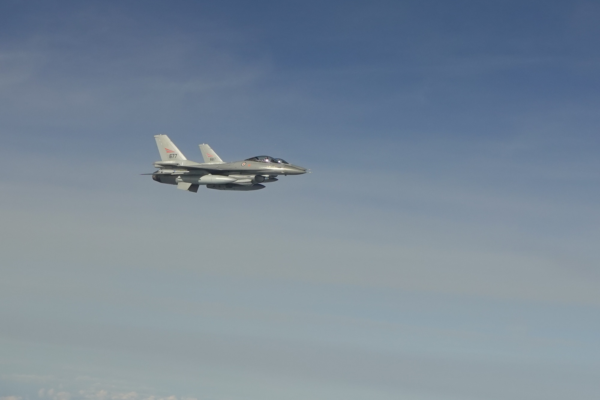 Two Norwegian air force F-16V Fighting Falcons accompany a B-1B Lancers assigned to the 345th Expeditionary Bomb Squadron during a training sortie over the Norwegian Sea, Sept. 25, 2020.