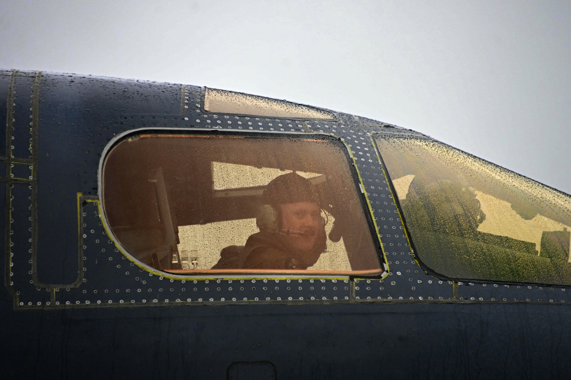 Photo of pilot looking out of the cockpit of a B-1 Lancer.