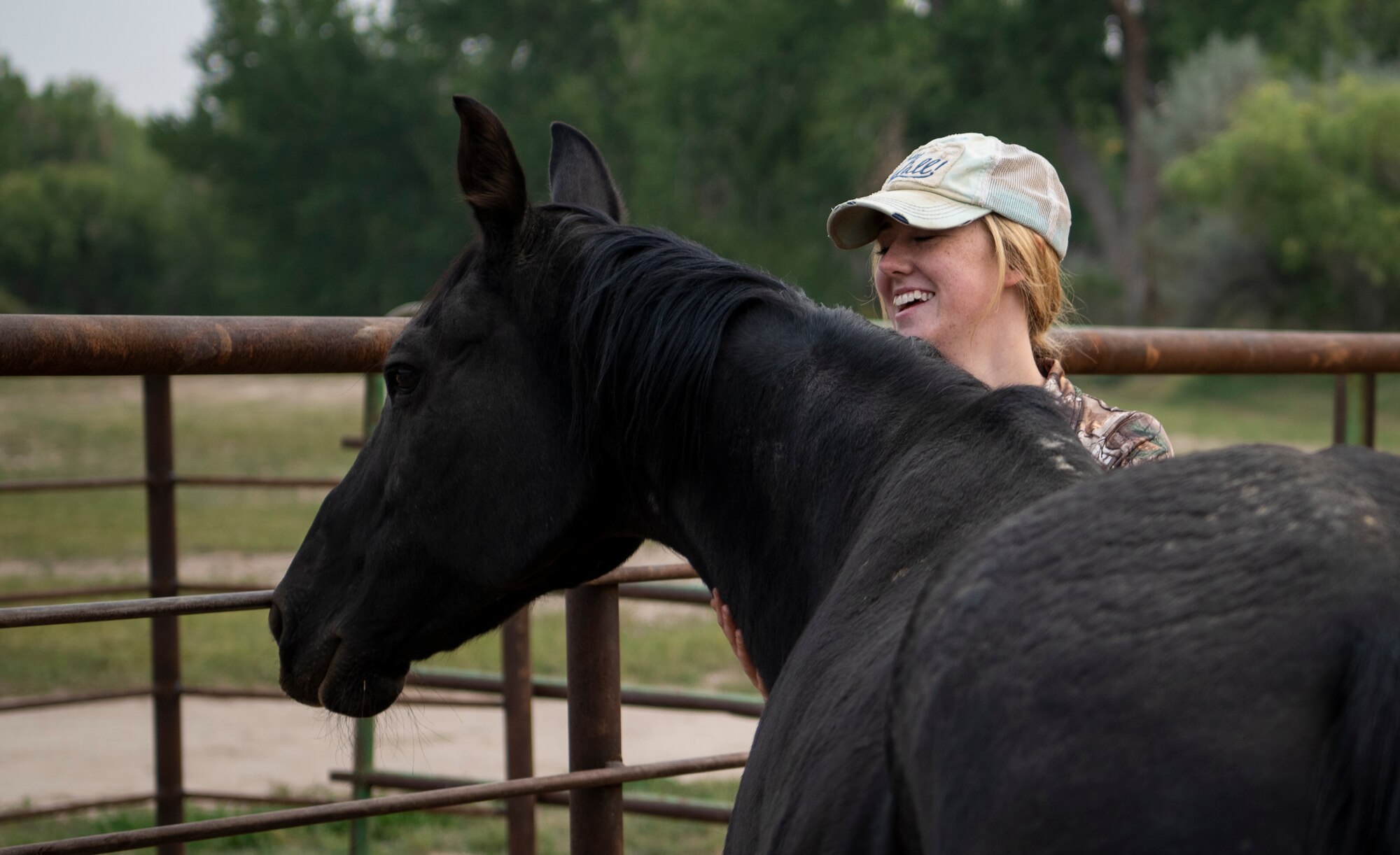 Airman Laycee Presutti, 21st Security Forces Squadron installation entry controller, pets a rescue horse at the Triple S Ranch in Colorado Springs, Colorado, Sept. 18, 2020. Prior to joining the Air Force, Presutti spent her free time interacting with horses, so when she arrived at her first duty station, she began volunteering at the ranch. She said the experience helps strengthen her resilience. (U.S. Space Force photo by Airman 1st Class Amanda Lovelace)