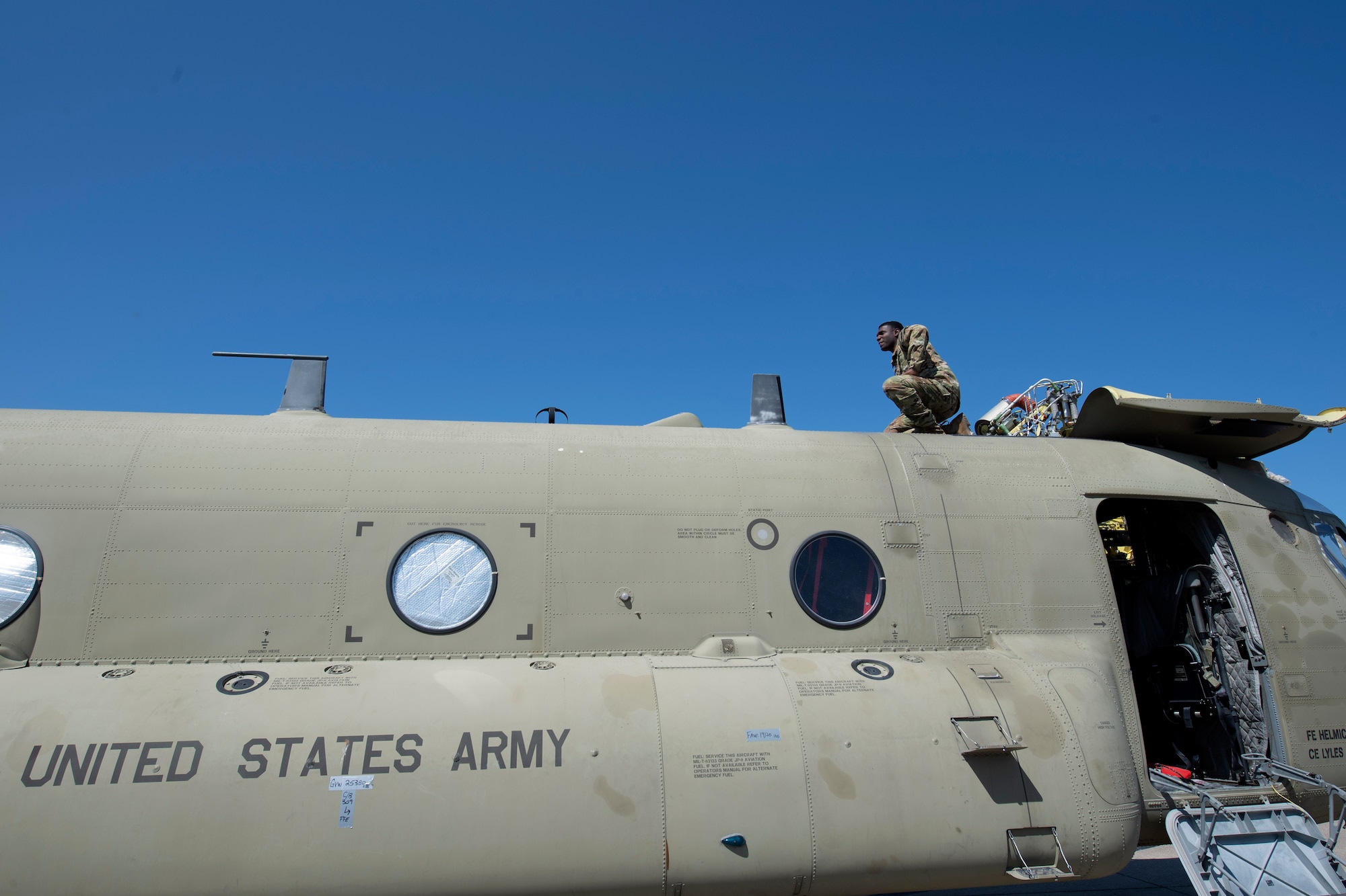 U.S. Airmen and Soldiers train together to load a Chinook-47 helicopter in a C-5M Super Galaxy.