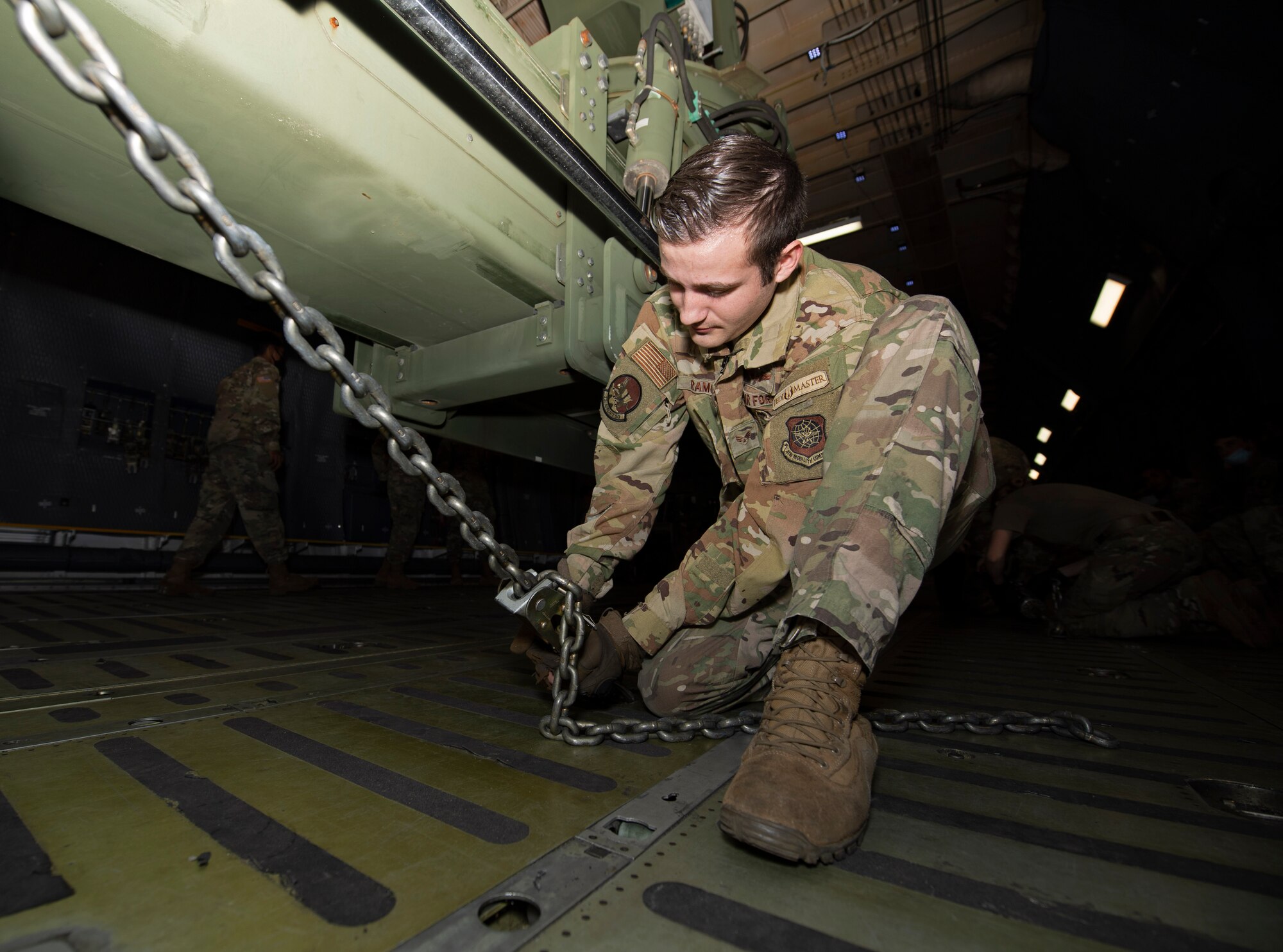 U.S. Airmen and Soldiers train together to load a Chinook-47 helicopter in a C-5M Super Galaxy.
