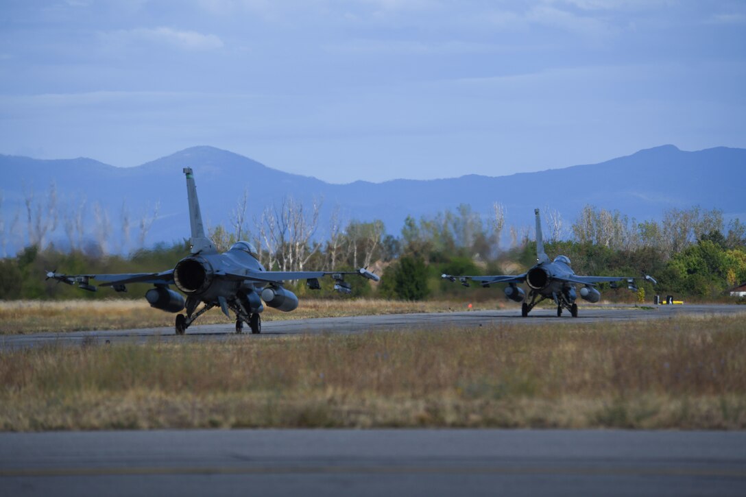 Two U.S. Air Force F-16 Fighting Falcons assigned to the 555th Fighter Squadron, Aviano Air Base, Italy, taxi on the runway during NATO’s enhanced Air Policing Allied mission at Graf Ignatievo Air Base, Bulgaria, Sept. 28, 2020. Airmen practiced responding to a quick reaction alert which built and maintained unit mission readiness and promoted interoperability with allies and partners. The presence of U.S. fighter aircraft in Bulgaria demonstrates NATO nations working together, maintaining and developing effectiveness at all levels. (U.S. Air Force photo by Airman 1st Class Ericka A. Woolever)