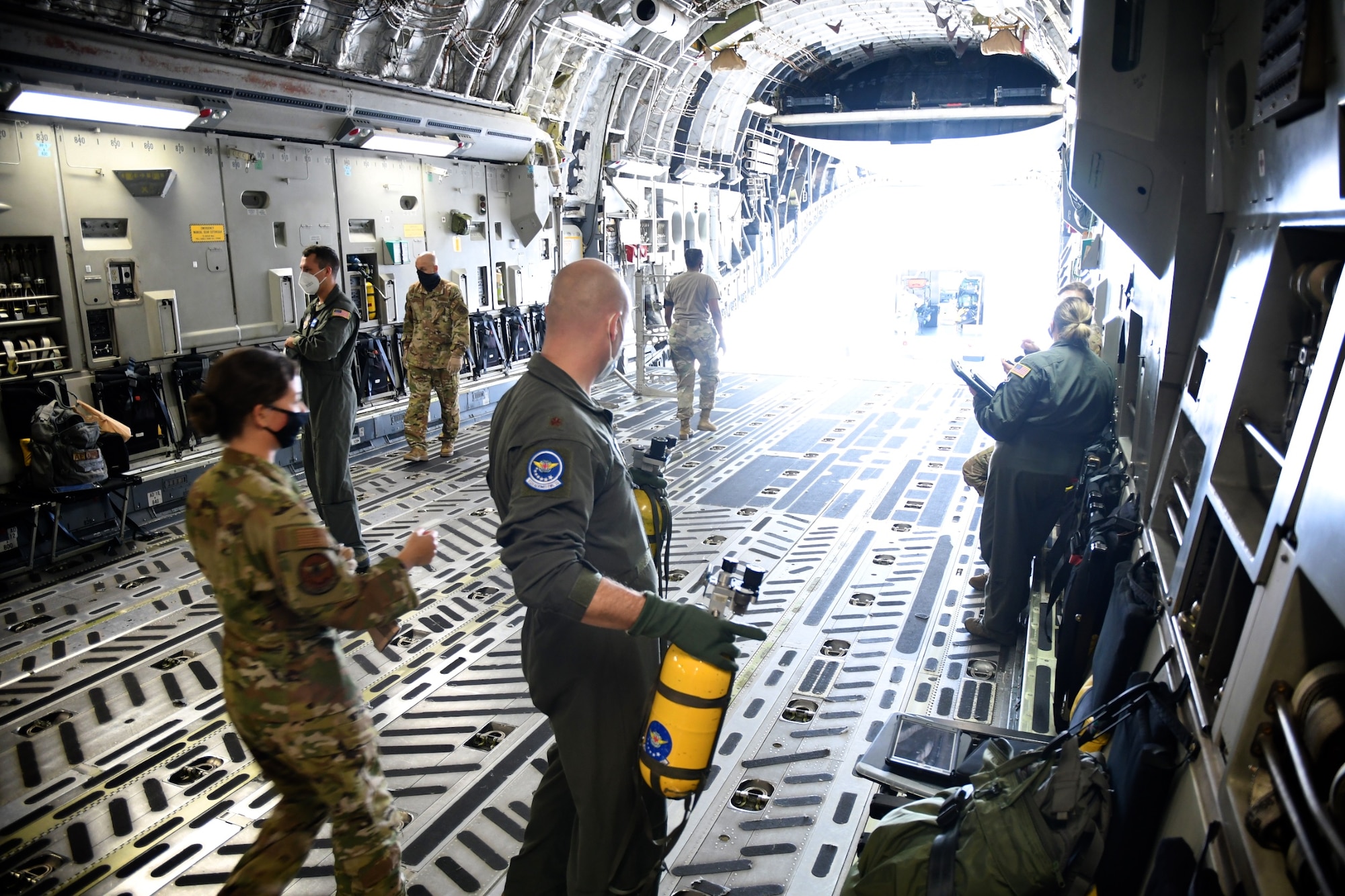 Despite the warm high 80's temperatures, a group of 932nd Aeromedical Evacuation Squadron (AES) members offload their medical gear from an equipment truck to a visiting C-17 aircraft September 27, 2020, Scott Air Force Base, Ill. The 932nd Airlift Wing worked improving and refining hands on skills at the unit which included members of the 131st Medical Group, Air National Guard, and 445th Airlift Wing, Air Force Reserve. Airmen worked together on first aid skills. Simulated patients were moved safely by litter from a waiting vehicle. The compact, highly-packed training was designed to improve skills and execute any future medical missions. (U.S. Air Force photo by Lt. Col. Stan Paregien)